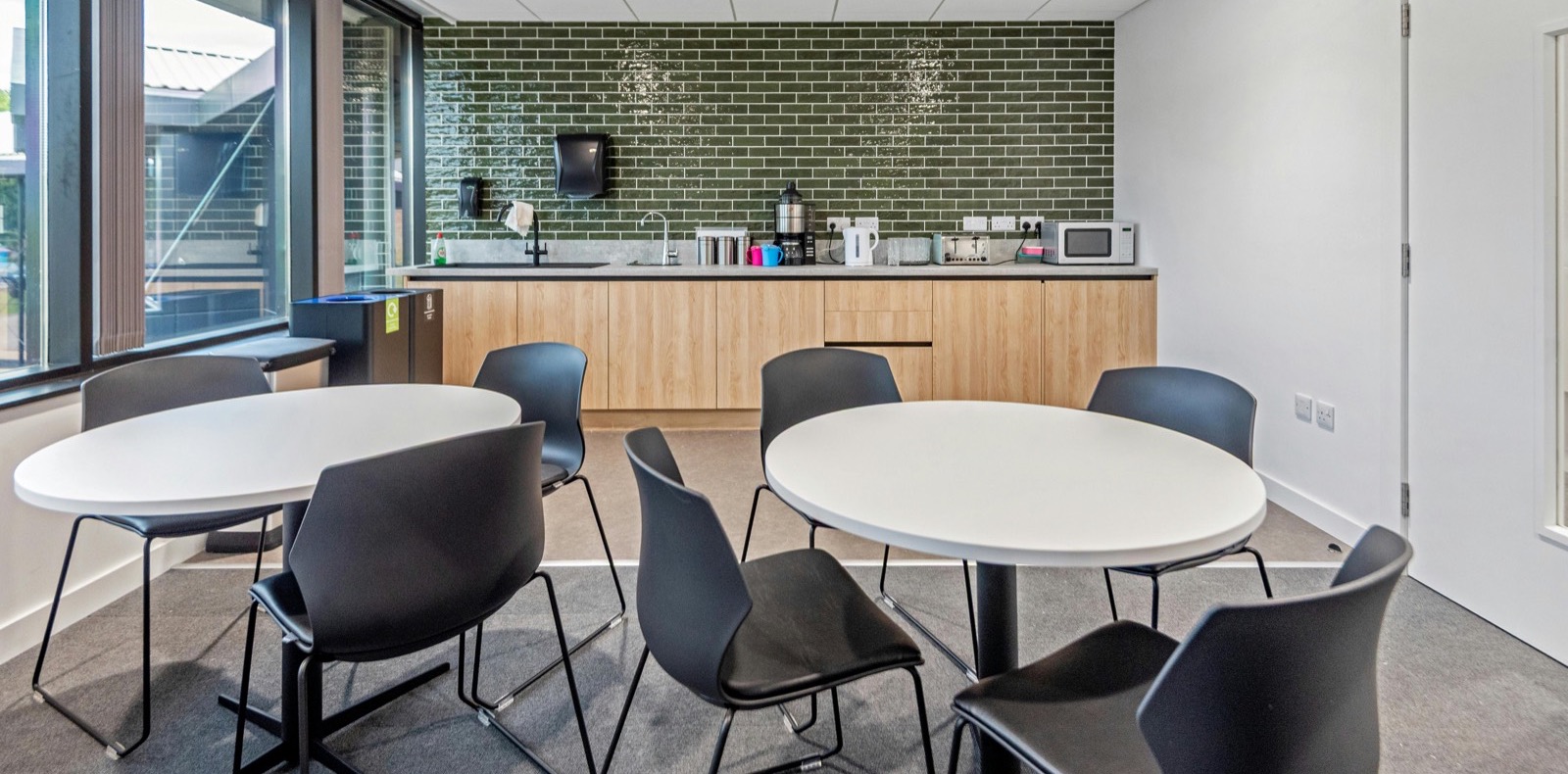 Refurbished office interior with exposed services and modern lighting.
